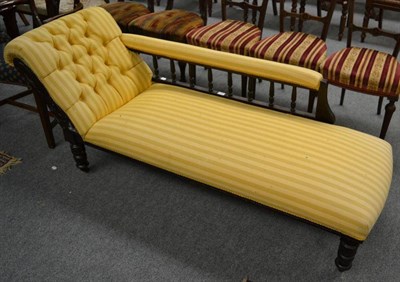 Lot 1277 - A Victorian ebonised chaise longue with cream striped upholstery