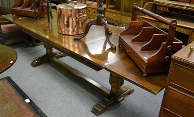 Lot 1292 - A large reproduction oak draw leaf table on stretcher base