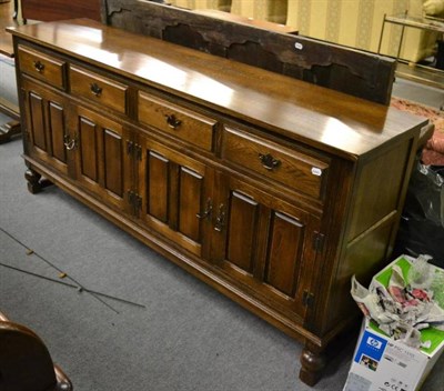 Lot 1297 - A modern oak sideboard with panelled door and four drawers