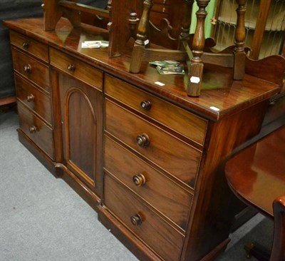 Lot 1311 - A Victorian mahogany dressing chest with seven drawers and carved back rail