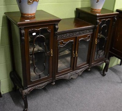 Lot 1313 - An Edwardian side cabinet with carved decoration and glazed doors