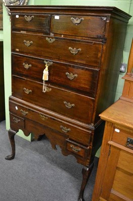 Lot 1331 - A Georgian oak chest on stand with mahogany inlay