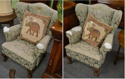 Lot 1335 - A pair of Victorian wing armchairs on claw and ball feet