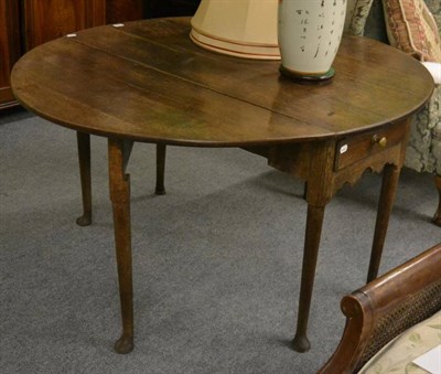 Lot 1337 - A late 18th century oak drop leaf table on pad feet