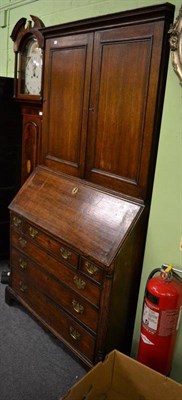 Lot 1340 - A Georgian oak bureau bookcase