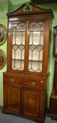 Lot 1344 - A Georgian mahogany inlaid secretaire bookcase