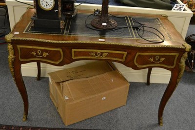 Lot 1345 - French serpentine shaped writing table with gilt metal mounts and black leather top