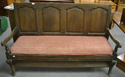 Lot 1355 - An 18th century and later panelled oak settle with drop in seat