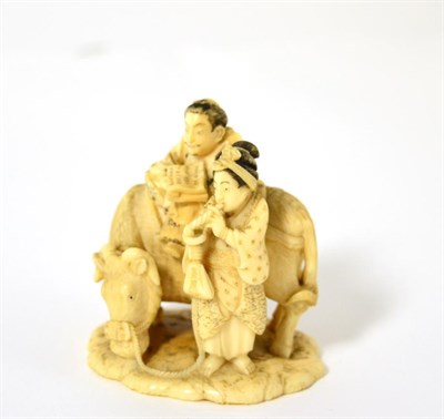 Lot 7 - A small Meiji period, Japanese ivory okimono of a man and woman with a water buffalo, signed to the
