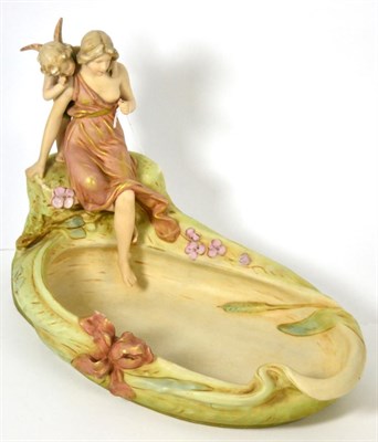 Lot 50 - Royal Dux figure modelled as maiden with putto and shell, 36cm diameter (a.f.)