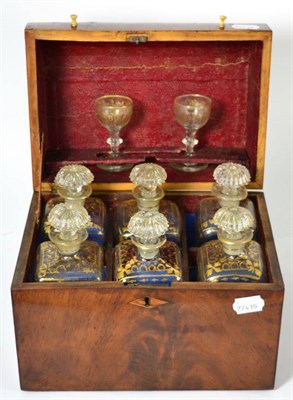Lot 62 - A George III mahogany six bottle decanter box, circa 1800, containing six gilt highlighted...