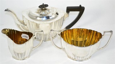Lot 82 - An Edwardian silver three piece tea service, comprising teapot, milk jug  and sugar bowl. Sheffield