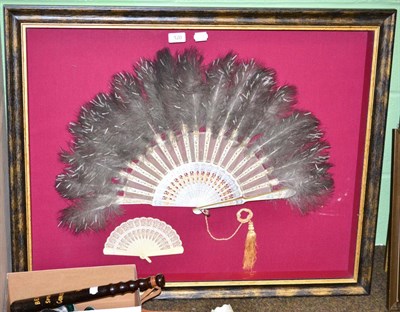 Lot 120 - South American feather fan on painted sticks and guards, celluloid fan (in a modern glazed...