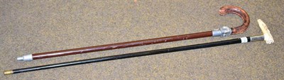 Lot 134 - An Edwardian ebonised walking stick with silver collar and rustic carved ivory handle and a...