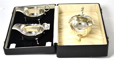 Lot 136 - A pair of Adie Bros silver sauce boats and a further silver sauce boat (3)