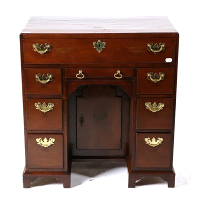 Lot 767 - A George II Mahogany Kneehole Desk, mid 18th century, with a long drawer above six graduated...