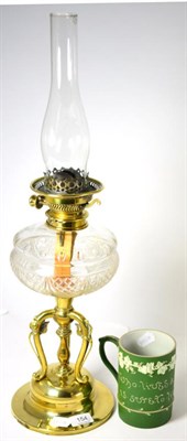 Lot 154 - An Art Nouveau brass pillar oil lamp with cut glass font and a Wedgwood Jasperware mug (2)