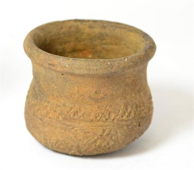 Lot 248 - An early terracotta vessel, possibly Bronze Age, with continuous stylised geometric decoration...