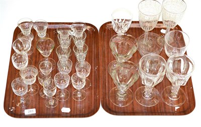 Lot 283 - A collection of drinking glasses including rummers and two engraved glasses (on two trays)