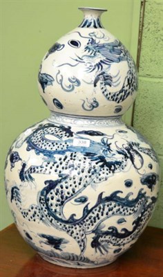 Lot 338 - A Chinese blue and white double gourd vase decorated with dragons and flaming pearls