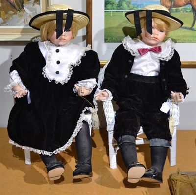 Lot 1027 - Alberon bisque figures, George & Georgina, in velvet costumes and sat in white painted wicker dolls