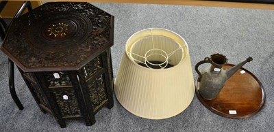 Lot 1045 - A mahogany circular tray, two lamp shades, an Eastern watering can and an Indian table