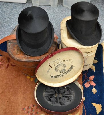 Lot 1073 - A black silk top hat initialled H W T M and a tan leather hat box and another in a card box,...