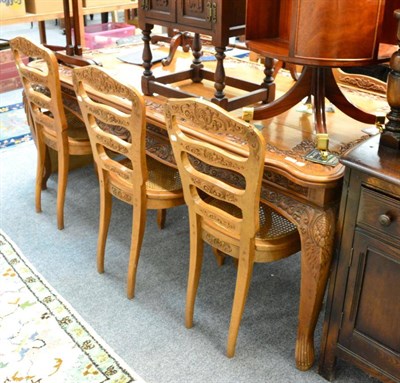 Lot 1120 - A carved cherrywood dining table and six chairs in the French style