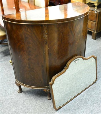 Lot 1123 - 1920s Waring & Gillow mahogany demi-lune cupboard and a mirror