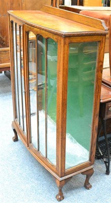 Lot 1128 - An oak glazed display cabinet and a Jones treadle sewing machine