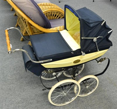 Lot 1155 - Silver Cross pram, with cream sides and navy covers, bearing an oval plague, no 0536