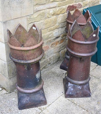 Lot 1157 - A set of three terracotta chimney pots with crown tops