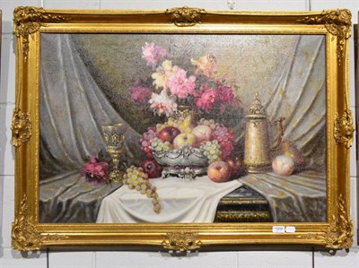 Lot 1200 - Bela Balagh (20th century) A still life of apples and grapes in a silver bowl with a goblet, a...