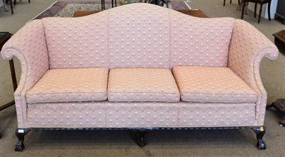 Lot 825 - A Victorian Carved Mahogany Camel-Back Sofa, late 19th century, recovered in pink and cream...