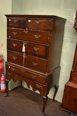 Lot 1299 - A Georgian oak chest on stand with mahogany inlay