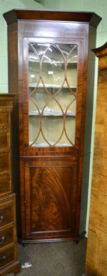 Lot 1304 - A Georgian mahogany standing glazed corner cabinet