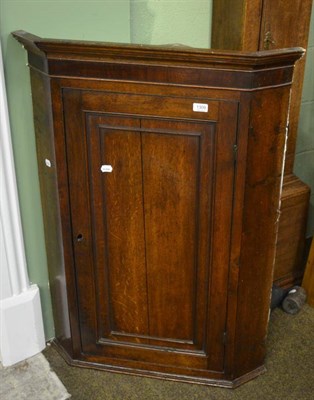 Lot 1309 - A Georgian oak and mahogany hanging corner cupboard