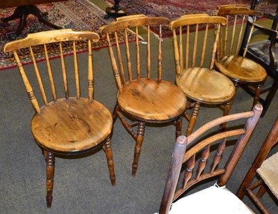 Lot 1373 - A set of four early 19th century provincial elm spindle back chairs