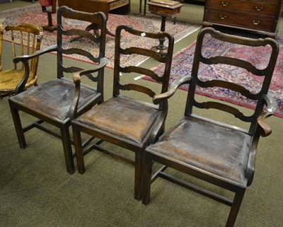 Lot 1375 - Set of three oak ladder back dining chairs, two with arms