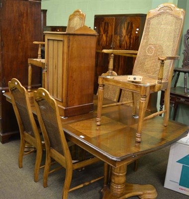 Lot 1398 - A French style walnut dining table and six cane back chairs