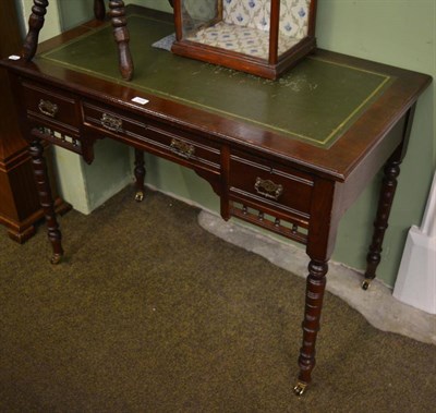 Lot 1405 - A leather inset writing table