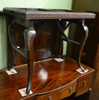 Lot 1408 - A carved Eastern occasional table with two lift out trays