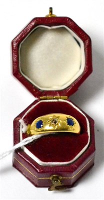 Lot 12 - A diamond and sapphire three stone ring stamped '18CT'