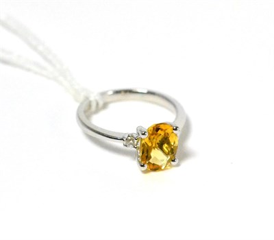 Lot 18 - A citrine and diamond three stone ring