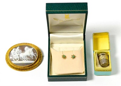 Lot 35 - An oval shell cameo brooch, a pair of gem set ear studs and a silver thimble