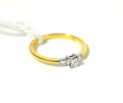 Lot 54 - An 18ct gold princess cut diamond ring with tapered baguette shoulders