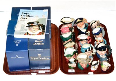 Lot 85 - A collection of Royal Doulton Toby Jugs on two trays, together with the 10th edition of the...