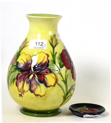 Lot 112 - A Walter Moorcroft Hibiscus pattern vase, on a yellow/green ground, impressed factory marks and...