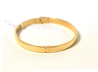 Lot 195 - A 9ct gold hinged oval bangle