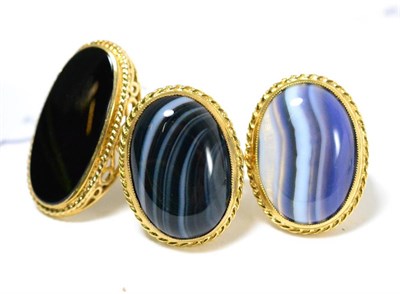 Lot 201 - A 9ct gold onyx ring and two 9ct gold banded agate rings